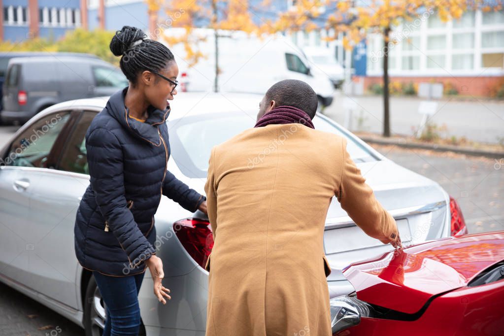 Young African Man And Woman Arguing With Each Other After Car Accident On Street