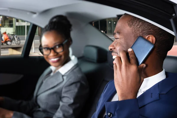 Happy Businessman Sitting Car His Female Colleague Talking Cellphone — стоковое фото