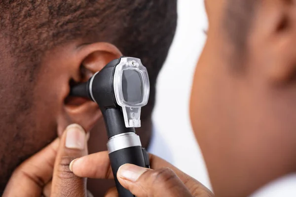 Africký Lékař Vyšetřující Ucho Mužského Pacienta Otočným Skopem — Stock fotografie