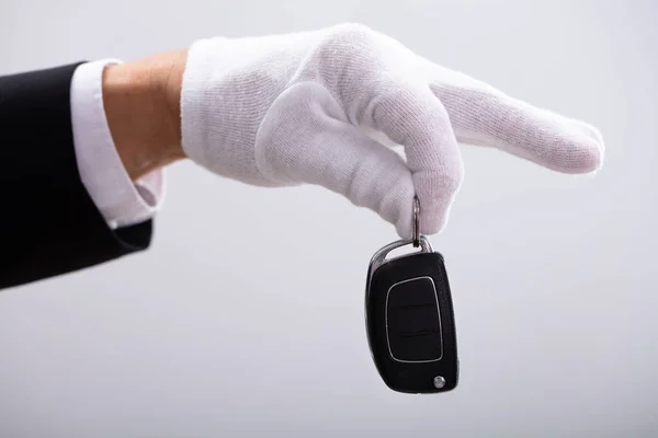 Valets Hand Hält Autoschlüssel Vor Weißem Hintergrund — Stockfoto