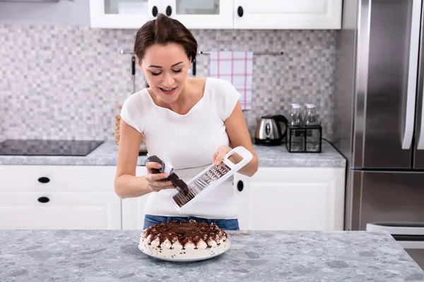 Portrait Smiling Young Woman Grating Chocolate Cake — Stock Photo, Image