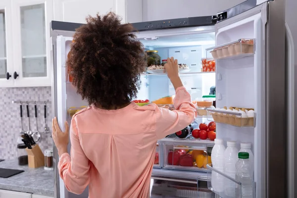 Buzdolabından Yemek Yemek Çekici Genç Bir Kadın Arkadan Görünüş — Stok fotoğraf