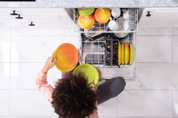 High Angle View Woman Arranging Colorful Plates Dishwasher Home — Stock Photo, Image