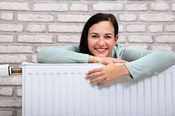 Portrait Happy Young Woman Leaning Heating Radiator — Stock Photo, Image