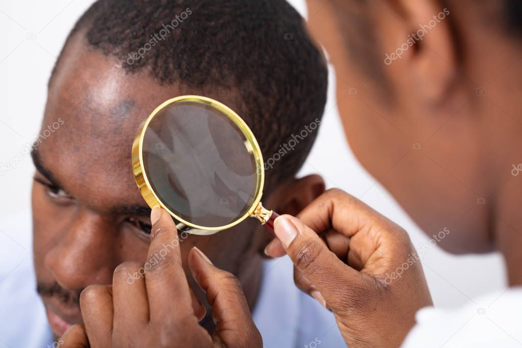 Close-up Of Man's Hair Seen Through Transparent Magnifying Glass