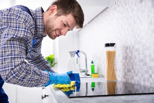 Jovem Homem Feliz Limpeza Indução Fogão Com Guardanapo Cozinha — Fotografia de Stock
