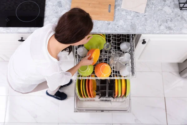 Smiling Young Woman Arranging Plates Dishwasher Home — Stock Photo, Image