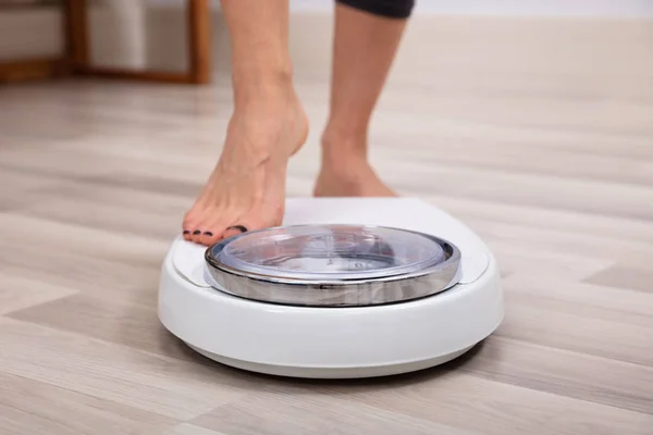 Close Human Foot Stepping Weighing Scale Hardwood Floor — Stock Photo, Image