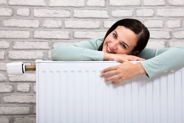 Portrait Happy Young Woman Leaning Heating Radiator — Stock Photo, Image