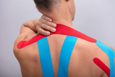 Shirtless Man With Physio Tape Applied On His Body. Body shape was altered during retouching clipart