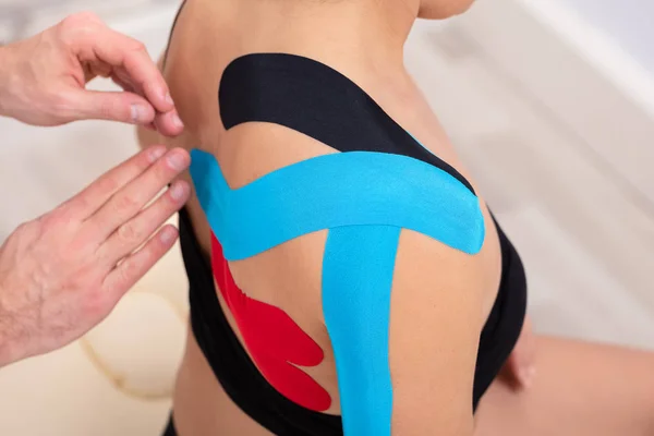 Man Hands Applying Physio Tape Woman Shoulder — стоковое фото