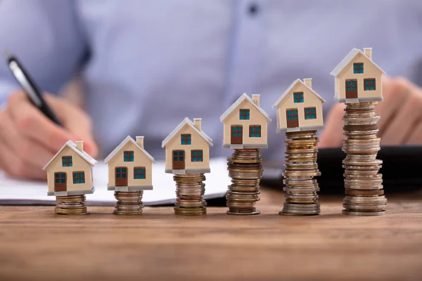 Midsection Businessman Calculating Invoice House Models Arranged Stacked Coins — Stock Photo, Image