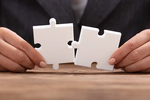 Close Businessperson Hand Trying Join Two White Jigsaw Puzzle — Stock Photo, Image