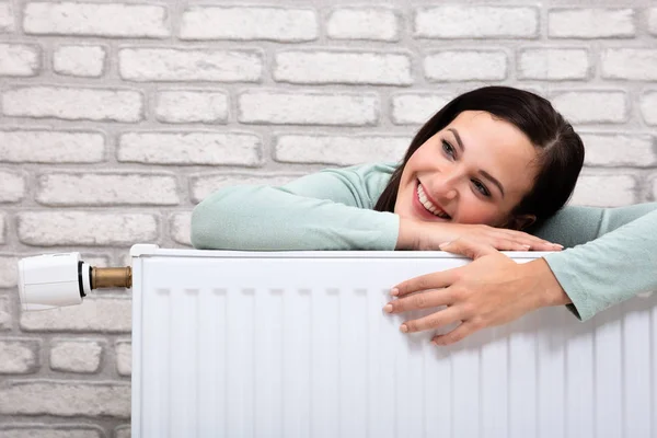 Portrait Happy Young Woman Leaning Heating Radiator — Stock Photo, Image