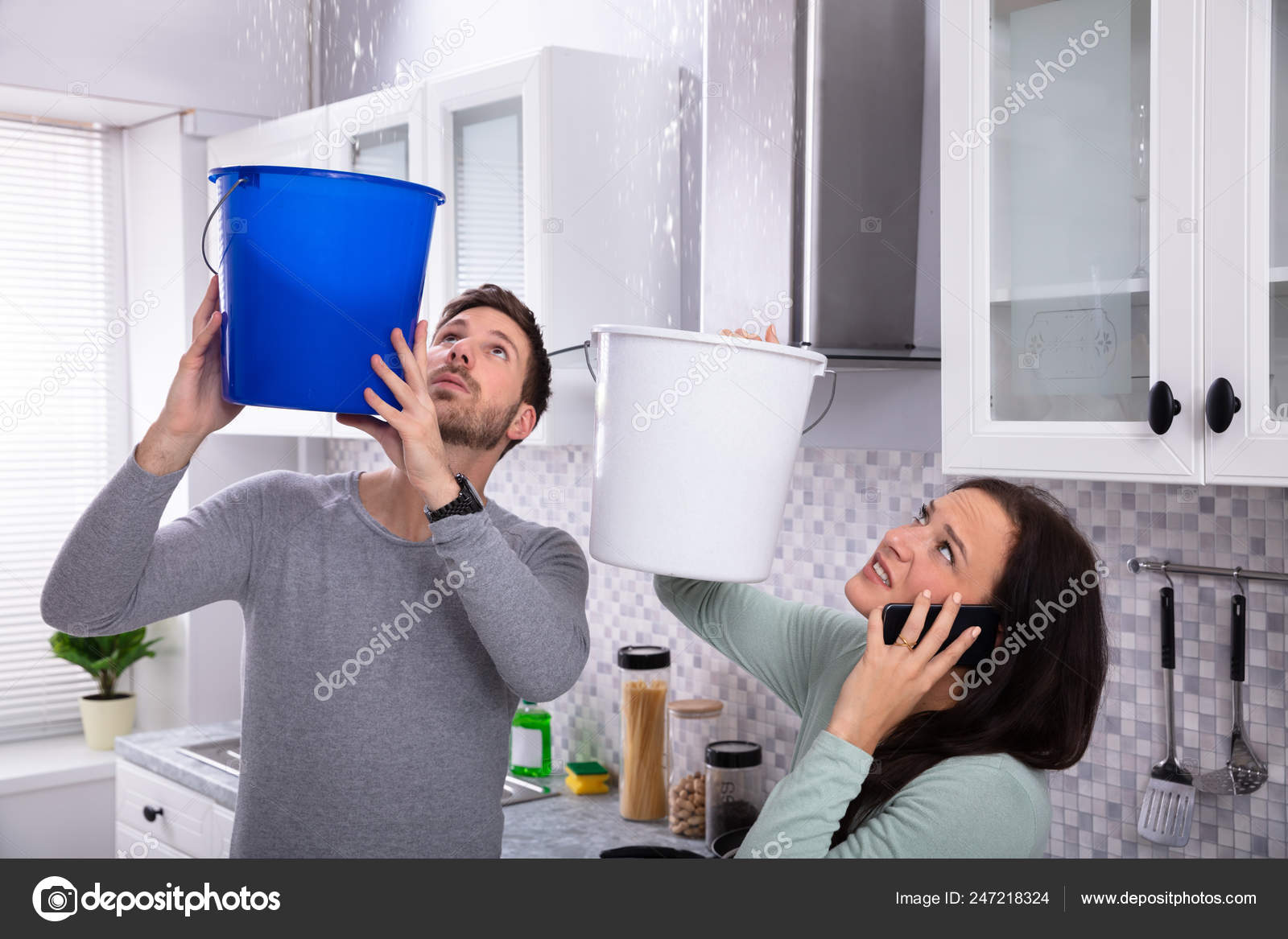 Worried Young Woman Calling Plumber Cellphone While Man