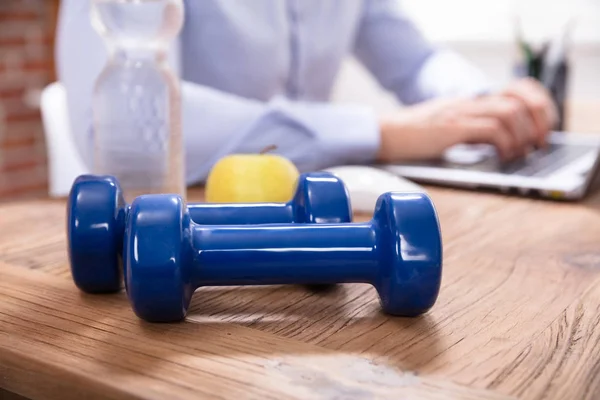 Businessperson Working Laptop Sitting Water Bottle Blue Dumbbells Office Desk — Stock Photo, Image