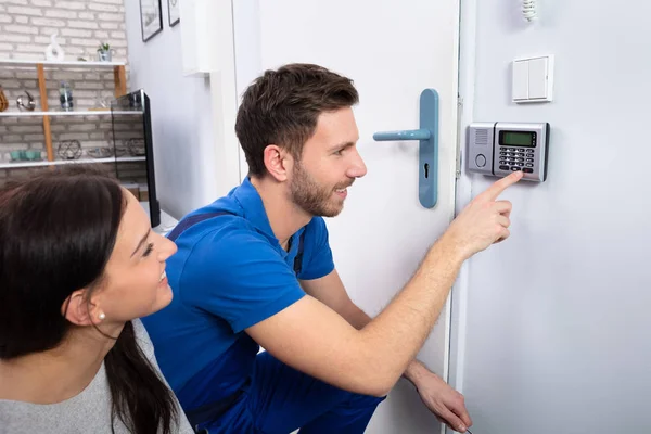 Close Handyman Installing Security System Door Wall While Woman Using — Stock Photo, Image