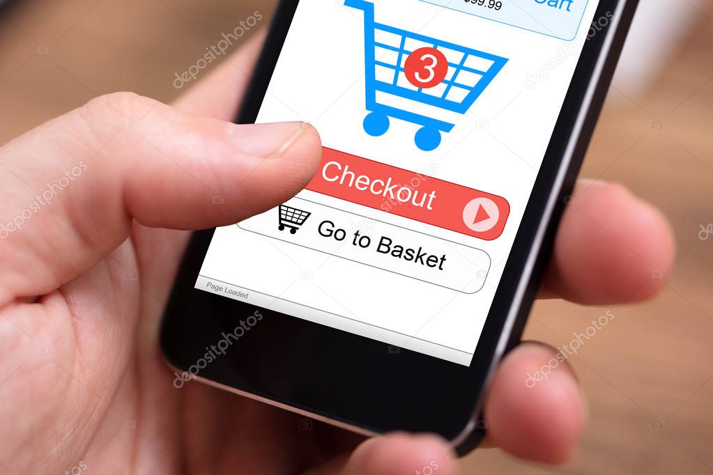 Human Hand Holding Mobile Phone With Online Shopping Application