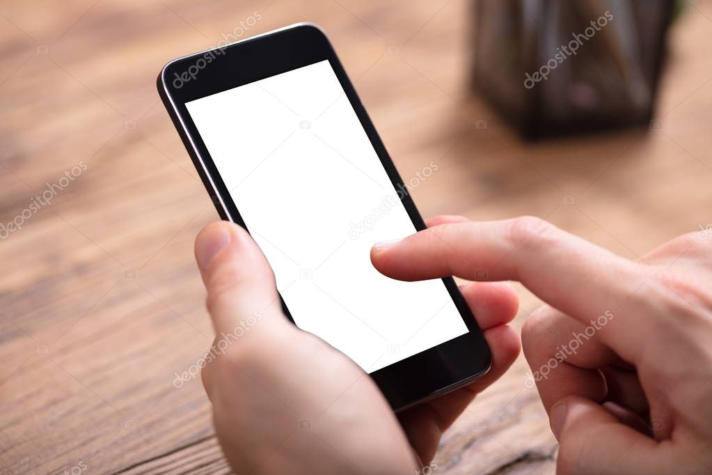 Close-up Of Person's Hand Holding Cellphone With Blank Screen