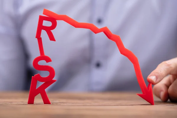 Businessperson Ukazující Červená Zmenšující Šipka Tam Riziko Text Dřevěné Desce — Stock fotografie
