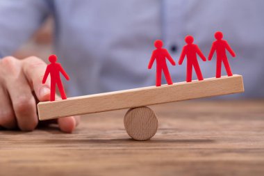 İşadamı 'nın Eli Tahta Masanın Üzerinde Tahterevalli Üzerinde Kırmızı Şekiller Arasında Dengesizlik Gösteriyor
