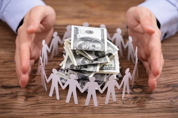 Person Hand Protecting Stacked Banknotes Surrounded Human Figures — Stock Photo, Image