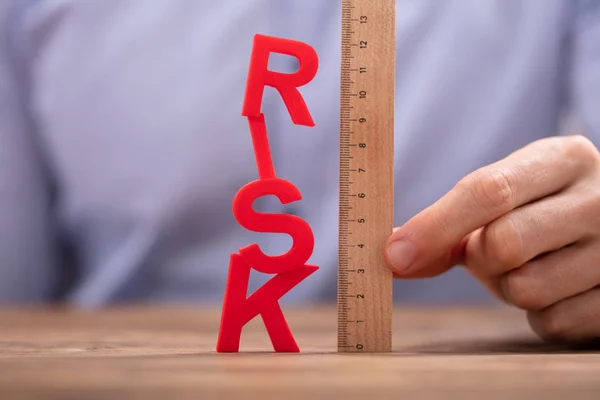 사람의 Wooden Ruler Red Risk Word — 스톡 사진