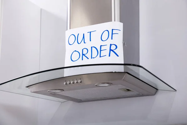 Written Text Out Of Order Message On Paper Over The Stuck Extractor Filter In Kitchen
