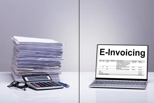 Stacked Of E-invoice Paper And Calculator Is Replace With New Technology Against White Background