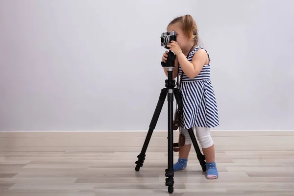 Mała Niewinna Dziewczyna Stojąca Podłodze Robiąca Zdjęcia Aparatem Fotograficznym Statywem — Zdjęcie stockowe