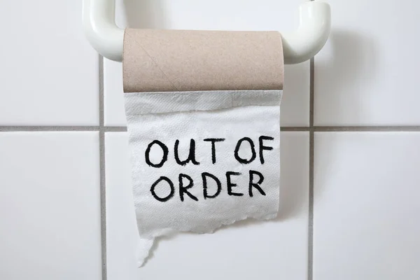 Written Text Out Of Order Message On Toilet Paper Roll In Bathroom