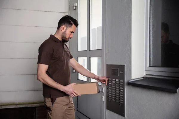 Side View Man Holding Cardboard Box Pressing Button Intercom Enter — стоковое фото