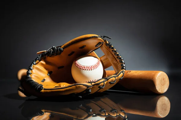 黒い背景に野球とバットを持つレザーグローブのクローズアップ — ストック写真
