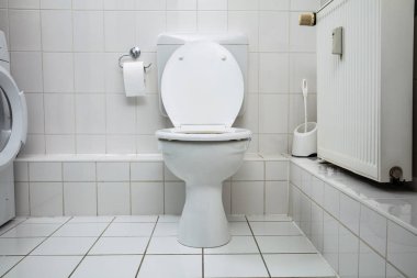 White Toilet Bowl In A Clean Hygienic Bathroom clipart