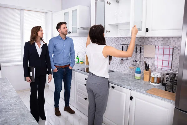 Young Woman Checking Kitchen Cabinet Meeting Real Estate Agent — Stock Photo, Image