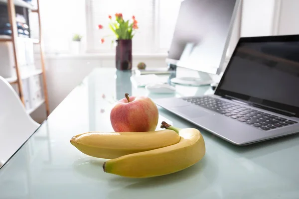 Apple And Laptop On Desk In Office