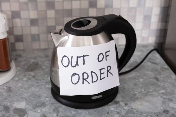 Written Text Out Of Order Message On Paper Over The Stuck Electrical Kettle