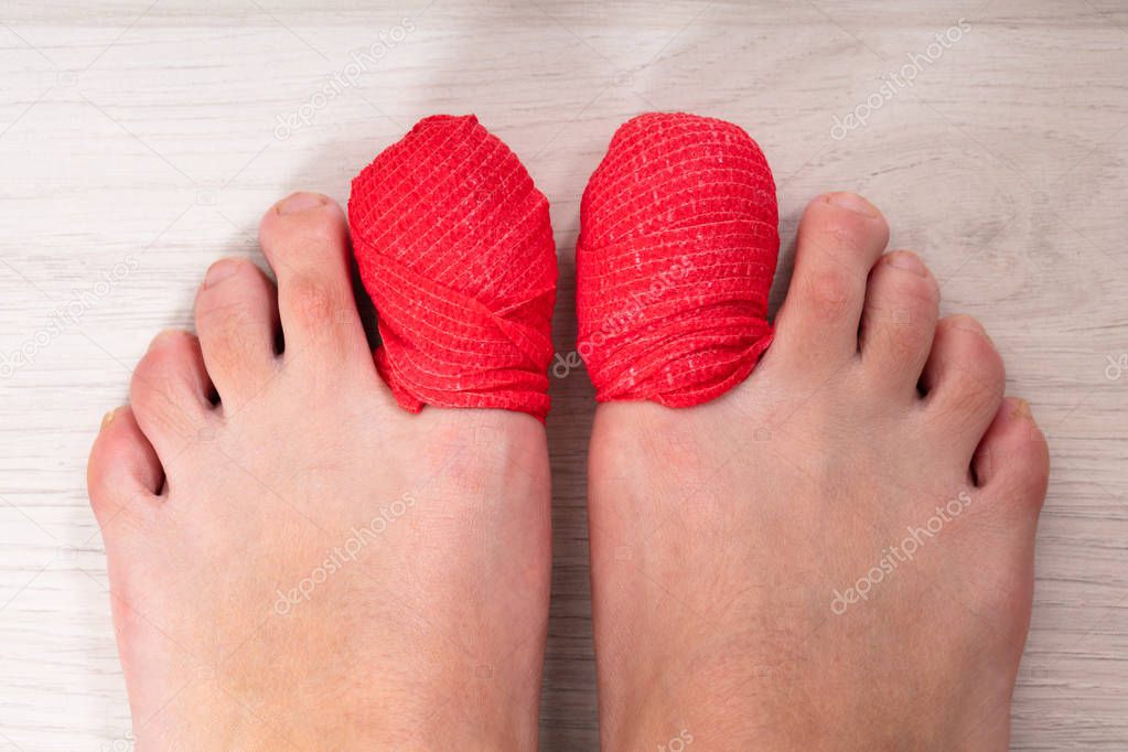 Close-up Of Human's Leg With Red Bandage On Sore Toe Nail