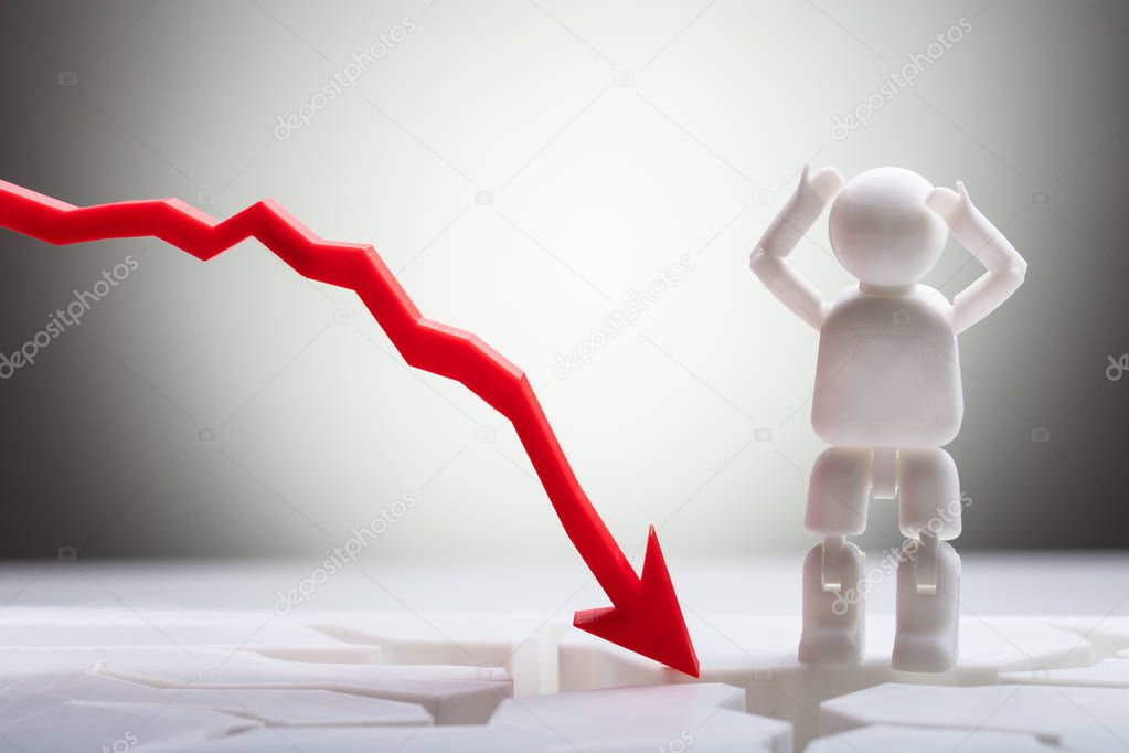 Close-up Of Human Figure Standing Near Red Arrow Symbol Moving In Downward Direction