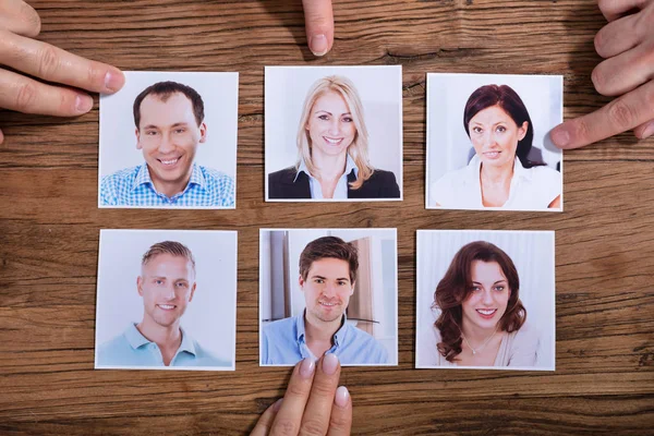 Elevated View Businesspeople Choosing Photograph Candidate Wooden Desk — Stock Photo, Image