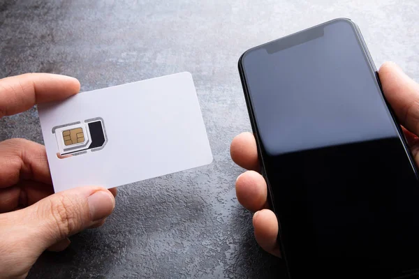 Mão Humana Segurando Cartão Sim Perto Smartphone Fundo Concreto — Fotografia de Stock