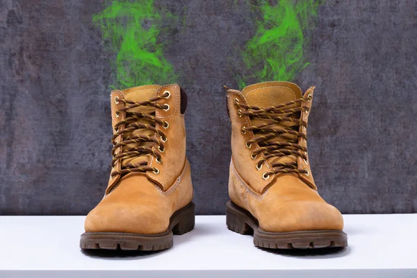 Pair Dirty Boots Unpleasant Smell Kept White Desk — Stock Photo, Image