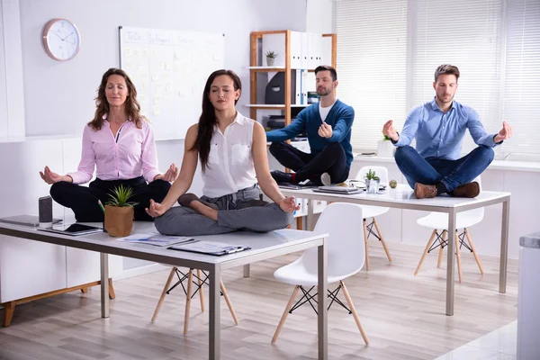 Young Businesspeople Sitting Desk Meditating Office — Stock Photo, Image