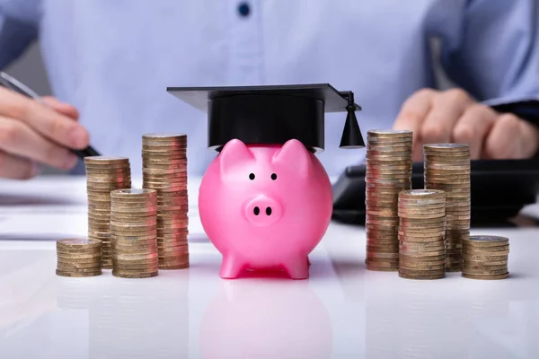 Close Piggy Bank Wearing Graduation Hat Stacked Coins Front Businessperson — Stock Photo, Image