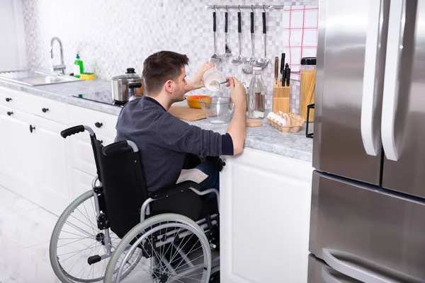 Young Disabled Man Sitting Wheel Chair Preparing Food Kitchen — Stock Photo, Image