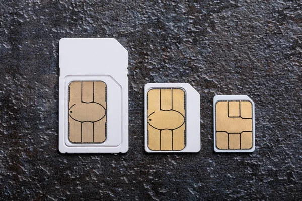 Three Types Sim Cards Arranged Row Concrete Gray Background — Stock Photo, Image