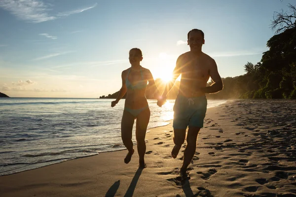 Sol Resplandor Sobre Silueta Pareja Joven Sosteniéndose Las Manos Corriendo —  Fotos de Stock