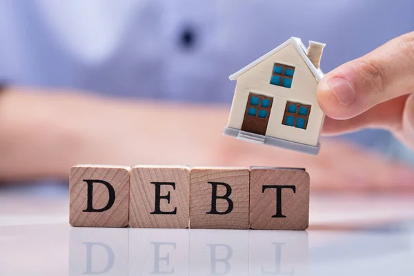 Businessman Hand Placing House Models Wooden Debt Cubic Blocks Reflective — Stock Photo, Image