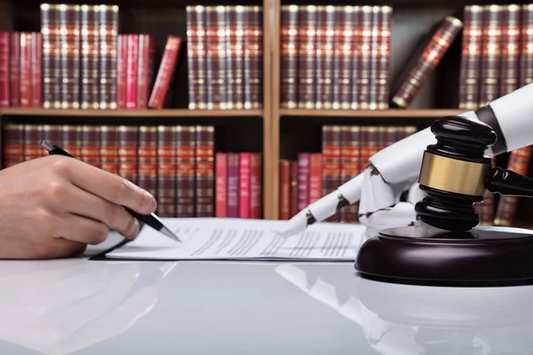 Robotic Hand Assisting Person Signing Document Reflective Desk Courtroom — Stock Photo, Image