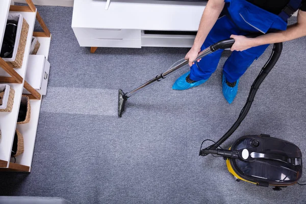 Close Male Janitor Using Vacuum Cleaner Cleaning Carpet Living Room — Stok Foto